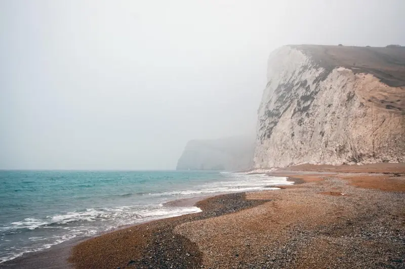 A pebble beach under chalk-grey cliffs